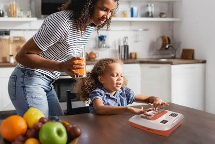 Woman and child in a kitchen with a Annie Device