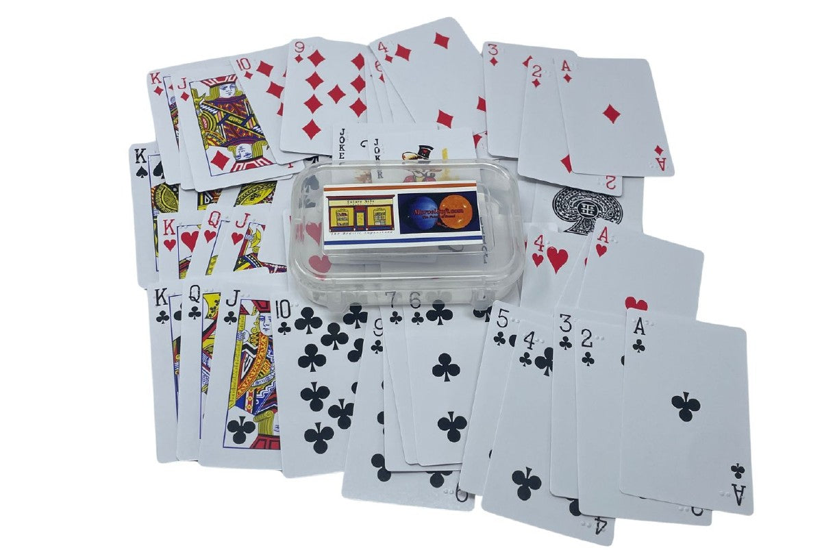 Plastic container with braille playing cards scattered below