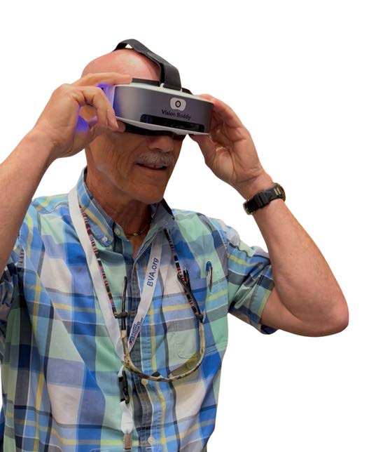 Man wearing a blue plaid shirt using a Vision Buddy Mini headset on a white background