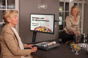 A woman reading a recipe on the Clearview C HD Flat Panel