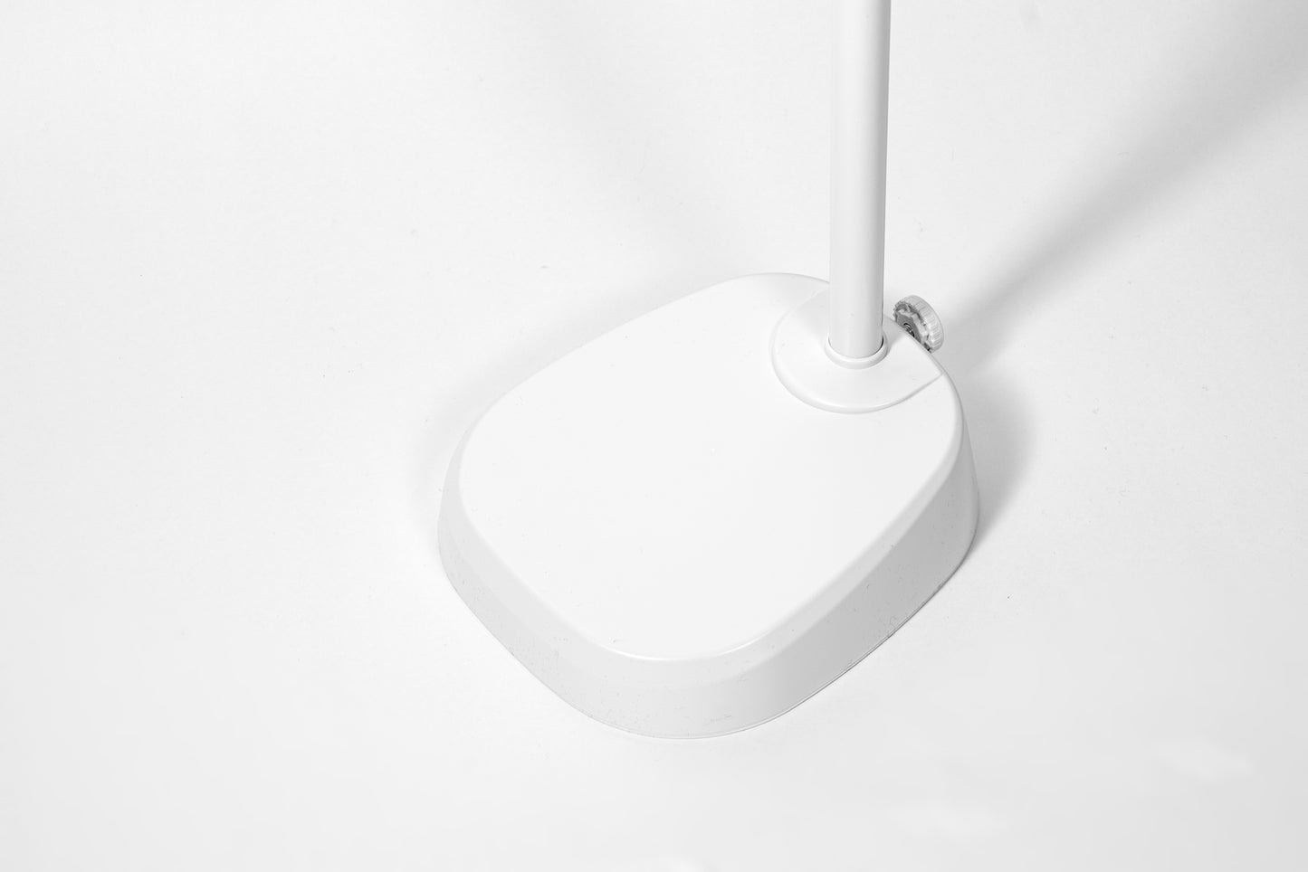 White base of lamp with adjustable knob showing.