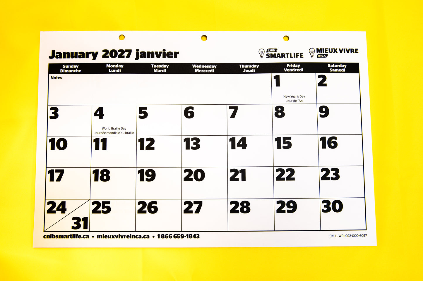 A 2027  CNIB SmartLife Calendar in French and English, photographed against a yellow background. 