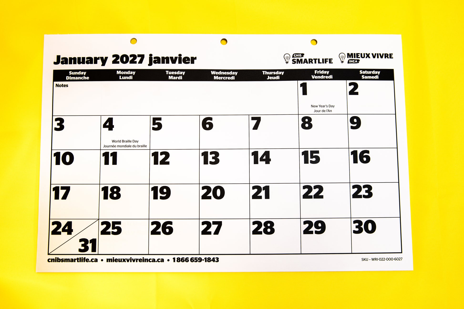 A 2027  CNIB SmartLife Calendar in French and English, photographed against a yellow background. 