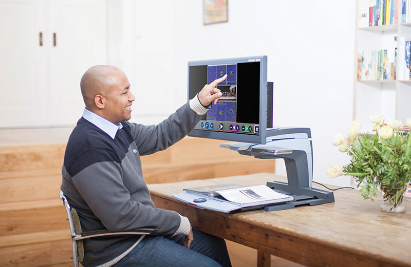 Person using the Clearview + at a desk.