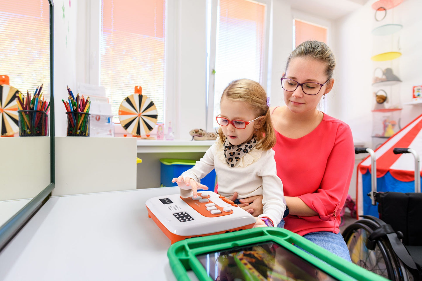 Woman and child using the Annie device in a classroom setting