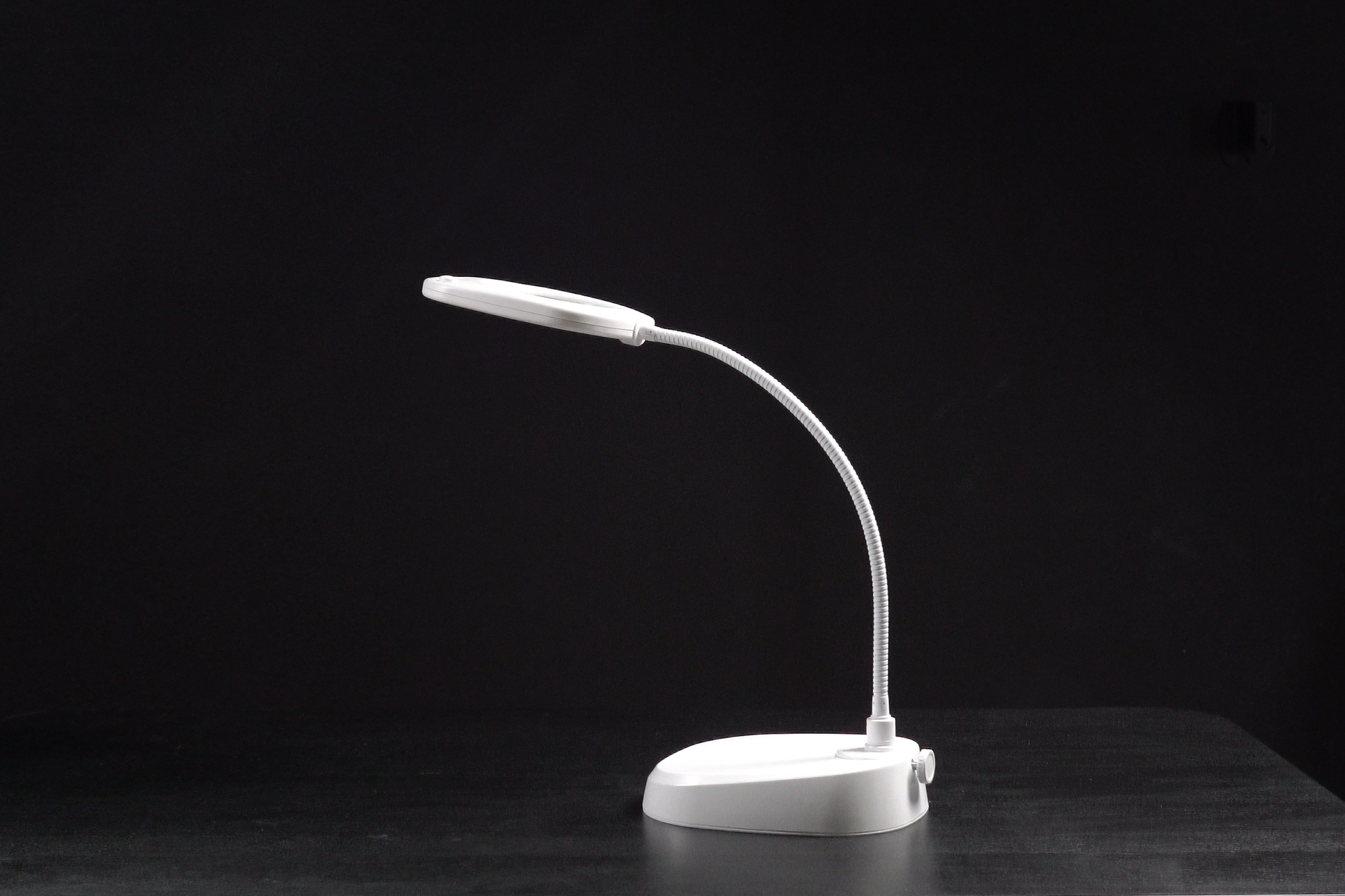 White LED desk lamp on a black background