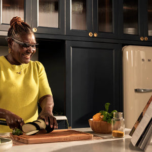 A woman cooking in the kitchen with the Envision Glasses on
