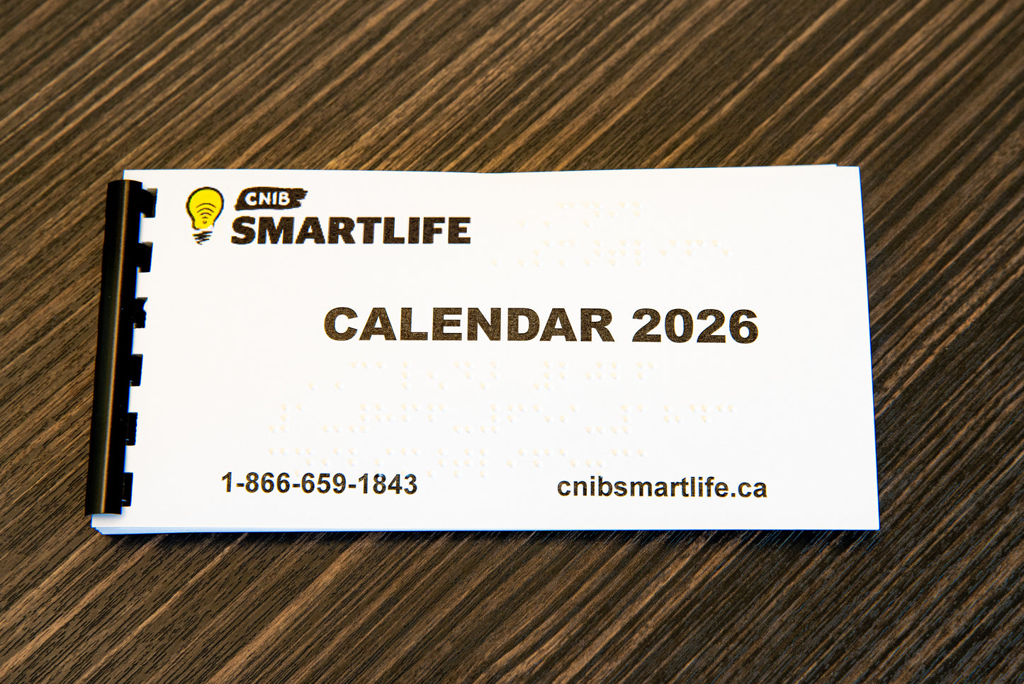 CNIB SmartLife 2026 calendar on a wooden surface