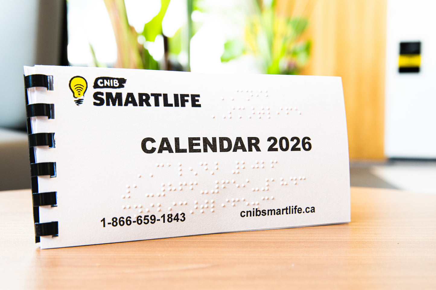CNIB SmartLife 2026 calendar on a desk with a blurred background