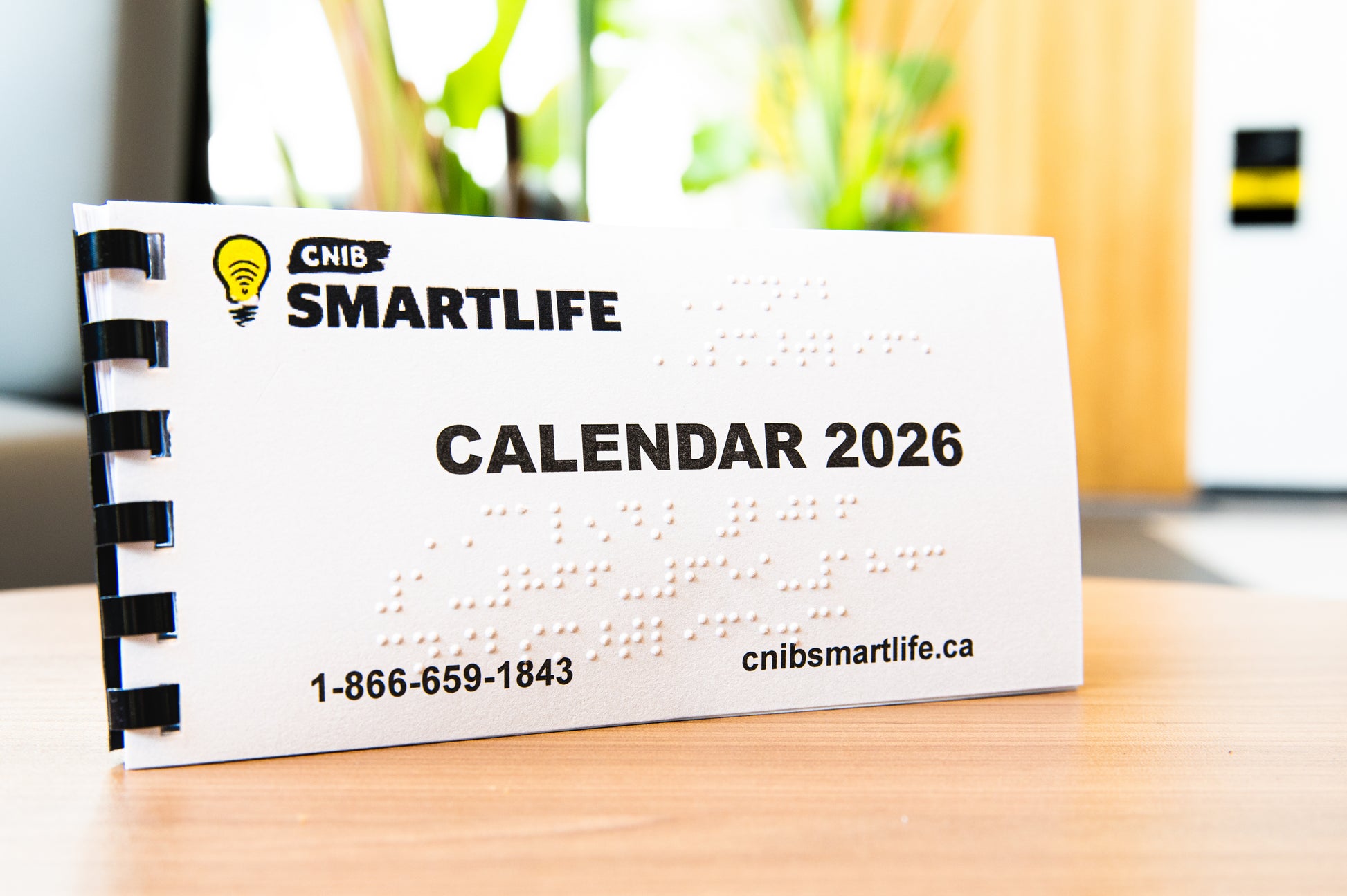 CNIB SmartLife 2026 calendar on a desk with a blurred background