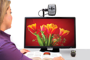 Image of a woman viewing a graphic of flowers from a book on an Acrobat Ultra 27 inch CCTV